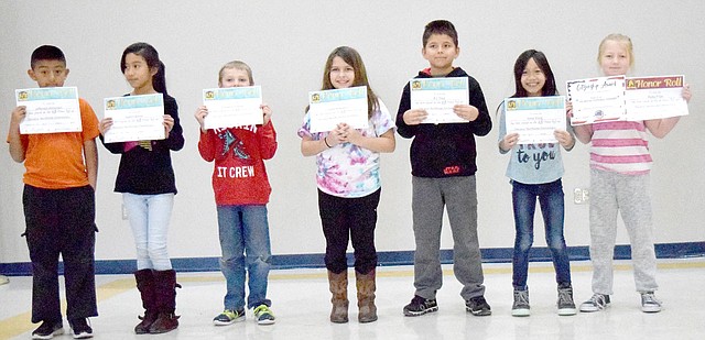 Westside Eagle Observer/MIKE ECKELS Leslie Thompson's third-grade class show off their second-quarter honor roll certificates received during the third- and fourth-grade honors assembly in the cafeteria at Decatur Northside Elementary school on Jan. 12. Receiving the awards were Jefferson Almengor (left), Jazmin Batres, Carson Courtney, Larea Echeverria, R.J. Trejo, Anna Xiong and Ruby Frye.