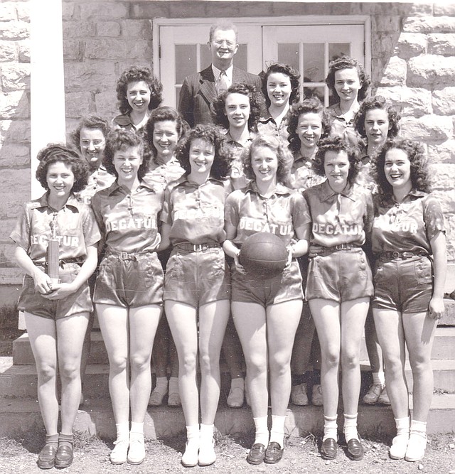 Westside Eagle Observer/SUBMITTED The 1945-46 Decatur High School senior girls' basketball team was photographed in front of the old high school (Decatur City Hall). Members included Ruby Austin (front, left), Barbara Jean Peek, Genevie Bredehoeft, Sally Hitch, Faye Dewey, Ruth Amos, Imogene Welch (row two, left), Mary Ackerman, Zelia Rae Sproies, Lila Miller, Kathryn Miller, Betty Bolch (row three, left), Barbara Vogelsang and Helen Martin. The school superintendent and girls' basketball coach, W.D. Barnes, is in the back row. Football and basketball was the topic of the first Decatur Historical Committee's movie night in the old gym (community room) in Decatur Jan. 22.