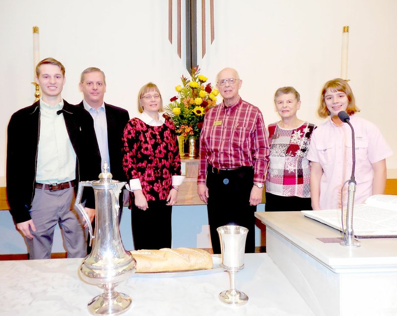 Photo submitted Joe and Barb Tropansky (right of the flower arrangement) of Bella Vista are pictured with their son, daughter-in-law and grandchildren, visiting from Spring Hill, Kan.