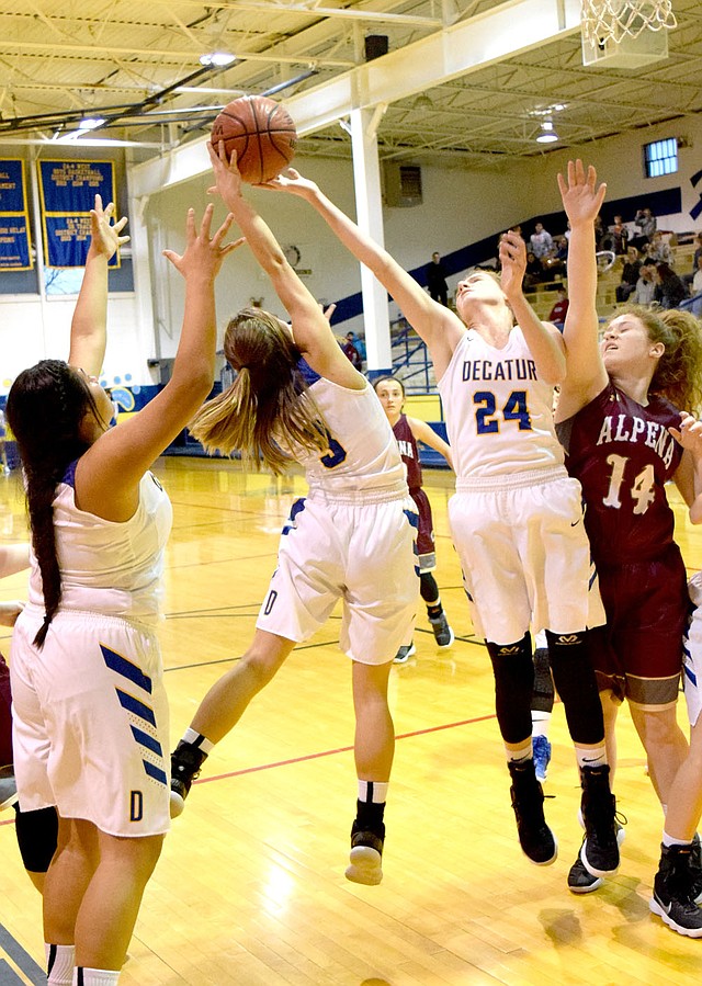 Westside Eagle Observer/MIKE ECKELS Destiny Mejia (Decatur 3) and Sammie Skaggs (Decatur 24) fight over an Alpena rebound during the Decatur-Alpena basketball contest Jan. 23 at Peterson Gym in Decatur.