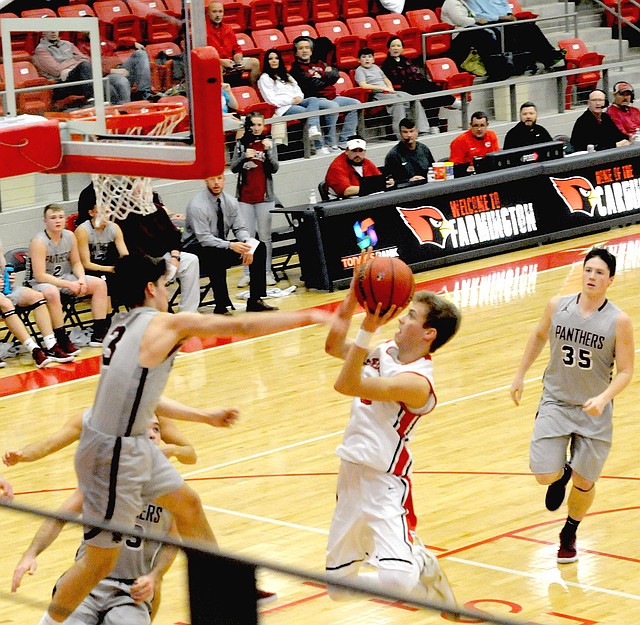 MARK HUMPHREY ENTERPRISE-LEADER Farmington senior Peyton Maxwell sails through the air on his way to another basket. Maxwell scored 30 points in the Cardinals' 71-65 overtime loss to Siloam Springs Friday at Cardinal Arena.