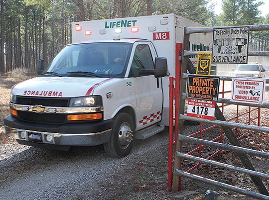 The Sentinel Record/Richard Rasmussen SHOOTING SCENE: A LifeNet ambulance exits the driveway at the scene of a shooting Tuesday morning at 4178 Highway 290. An unidentified man was transported from the scene with a gunshot wound to the lower back.