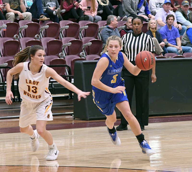 The Sentinel-Record/Grace Brown - Lakeside's Thea Rice (3) drives the ball as Lake Hamilton's Jenny Peake (13) defends during the basketball game at Wolf Arena on Tuesday, Jan. 30, 2018.