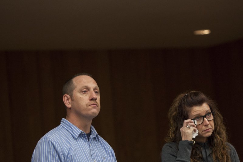 Tony Myers and Kristen Myers-Chatman react as their daughter, Chloe Myers, gives a video statement during Larry Nassar's sentencing at Eaton County Circuit Court in Charlotte on Wednesday, Jan. 31, 2018. The former Michigan State University sports-medicine and USA Gymnastics doctor is being sentenced for three first degree criminal sexual abuse charges related to assaults that occurred at Twistars, a gymnastics facility in Dimondale. (Cory Morse /The Grand Rapids Press via AP)