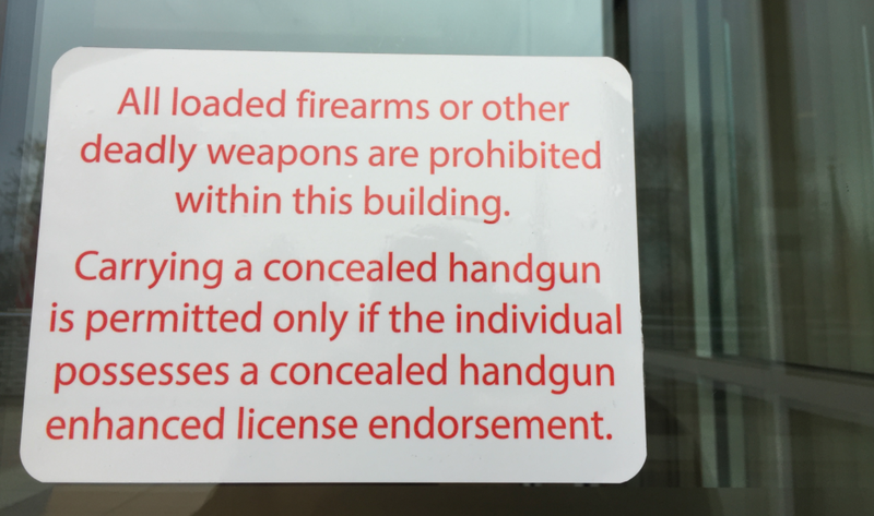 In Little Rock, signs have appeared on some public buildings, like this one at the Victory Building near the Arkansas Capitol, warning that guns are still off limits, except to those with the required permits. 
