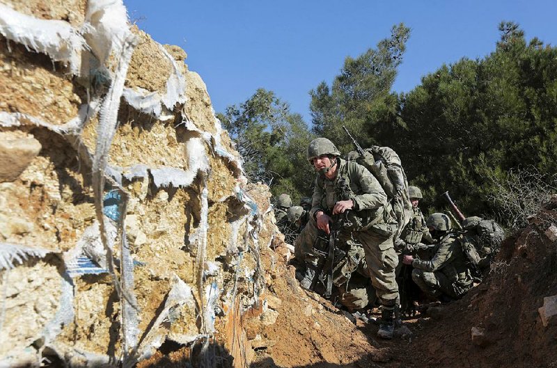 In an operation Sunday, Turkish troops try to take control of Bursayah hill, which separates the Syrian Kurdish-held area of Afrin from the Turkish-controlled town of Azaz. A rights group said Thursday that “crushing” battles were continuing between Turkish troops and the Kurdish fighters. 