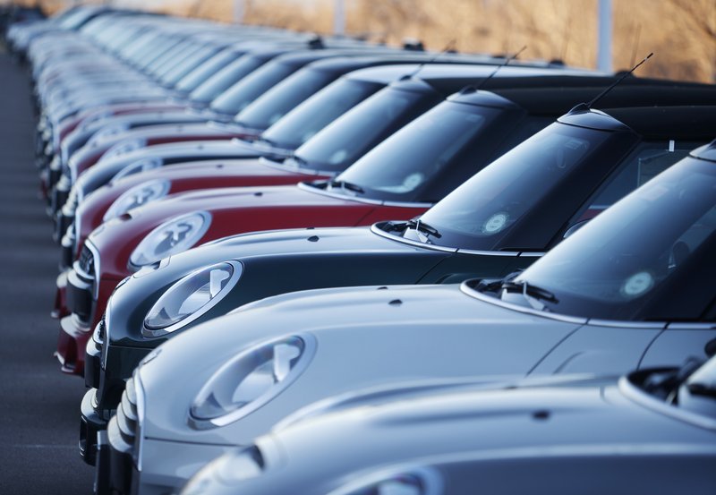 In this Sunday, Jan. 7, 2018, photograph, 2017 and 2018 Mini Coopers sit on a dealer's lot in Highlands Ranch, Colo. January 2018 U.S. auto sales are expected to grow just a little as rebates and other deals wane after a December buying spree. (AP Photo/David Zalubowski)