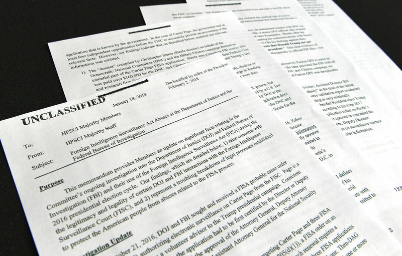 A intelligence memo is photographed in Washington, Friday, Feb. 2, 2018. After President Donald Trump declassified the memo, the Republican-led House Intelligence Committee released it based on classified information that alleges the FBI abused U.S. government surveillance powers in its investigation into Russian election interference.