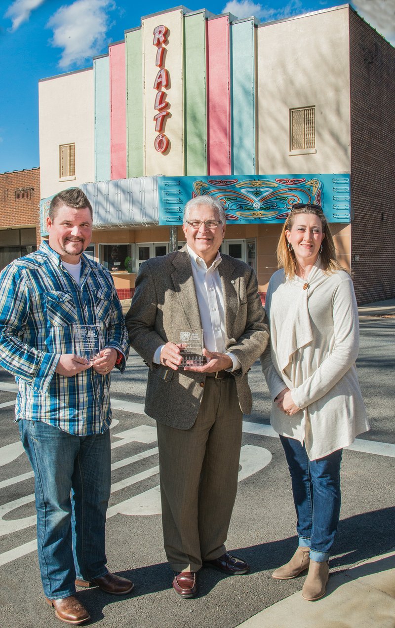 Main Street Searcy received two awards recently from the Main Street Arkansas program — the Best Downtown Public Improvement Award for work done around the Courthouse Square and Spring Street, and the Best Facade Restoration Award for work done at the historic Rialto Theater. Shown with the awards are, from left, Mike Parsons, director of the Searcy Parks and Recreation Department; Searcy Mayor David Morris; and Amy Burton, executive director of Main Street Searcy.