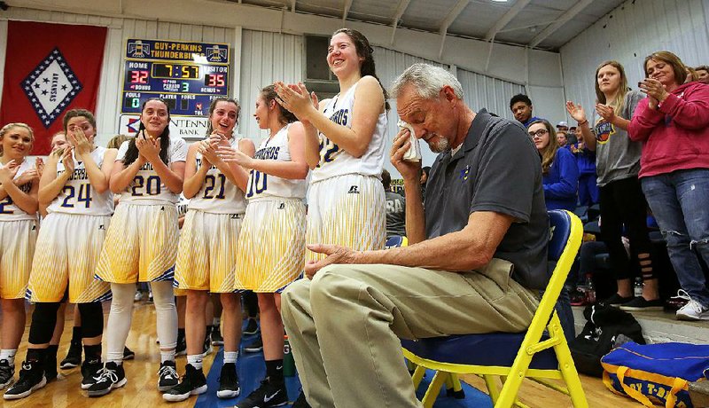 Guy-Perkins Coach John Hutchcraft (right) wipes away tears during a halftime ceremony Friday night. Hutchcraft, who has more than 2,000 career victories, is retiring after the season.