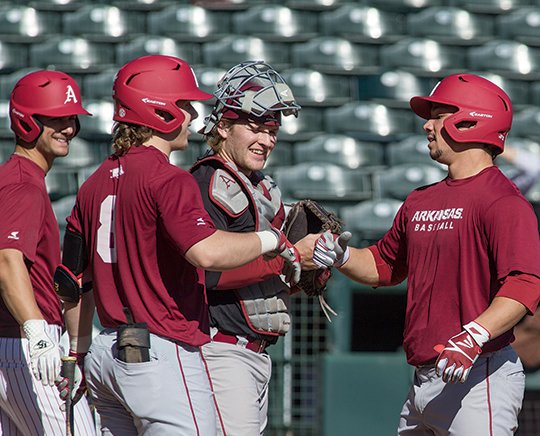 NWA Democrat-Gazette/Ben Goff STARTING HOME: Fellow starter Eric Cole (8) welcomes Dominic Fletcher, right, back to the plate after a home run, with catcher Grant Koch a week ago during a scrimmage at Baum Stadium in Fayetteville.