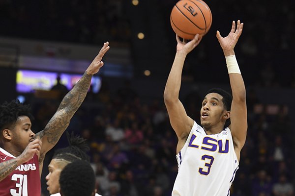 LSU's Tremont Waters (3) shoots a three-point basket in the first half of an NCAA college basketball game in Baton Rouge, La., Saturday, Feb. 3, 2017. Arkansas' Anton Beard (31) defends. (Patrick Dennis/The Advocate via AP)

