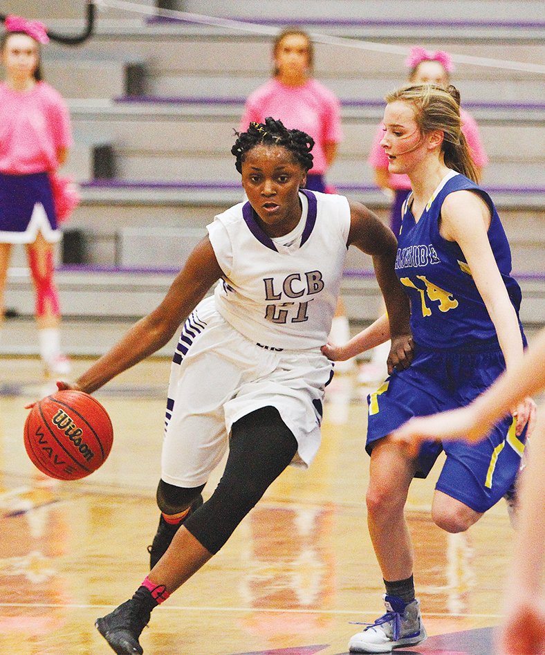 Terrance Armstard/News-Times El Dorado's Tasia Richardson (21) drives the ball against Hot Springs Lakeside's Chloe Porter (14) during their game at Wildcat Arena on Friday.