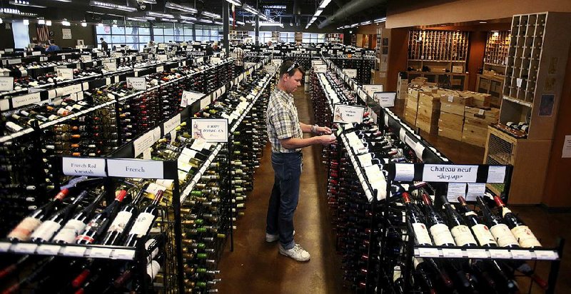 A state liquor store worker prices products in Salt Lake City, where an influx of out-of-state workers has fueled a steady rise in liquor sales over the past two decades. In Mormon-dominated Utah, alcohol use is frowned upon.