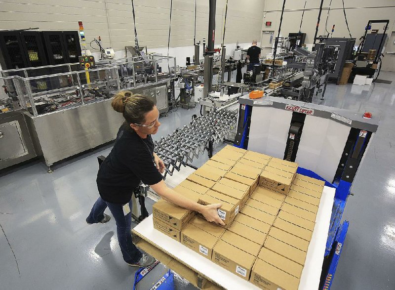 Denise Priest loads a pallet with boxes of ammunition Wednesday at the Sig Sauer plant in Jacksonville, which soon will be making new 9mm ammunition.