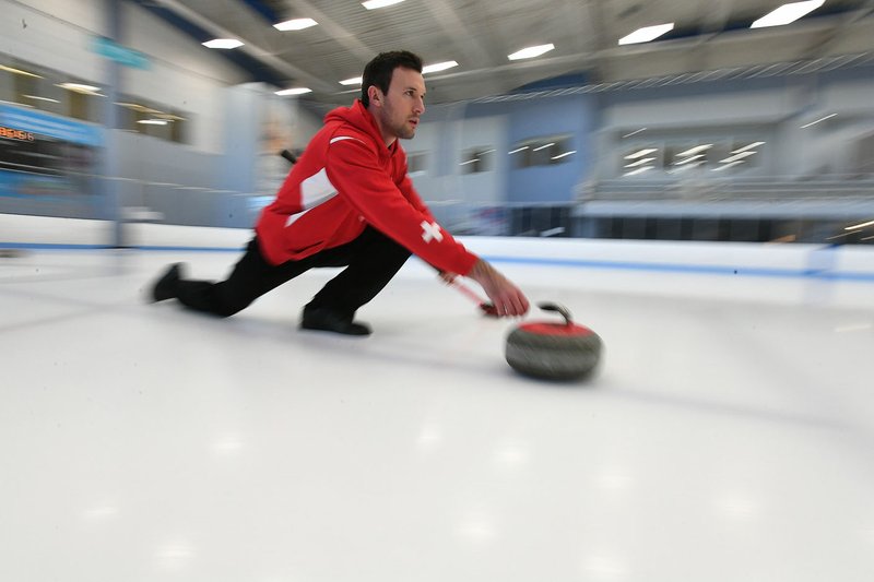 NWA Democrat-Gazette/J.T. WAMPLER Dominik Maerki of Fayetteville practices curling Thursday Jan. 25, 2018 at the Jones Center in Springdale. Maerki is a member of the Swiss curling team and will travel to the Winter Olympics in South Korea.