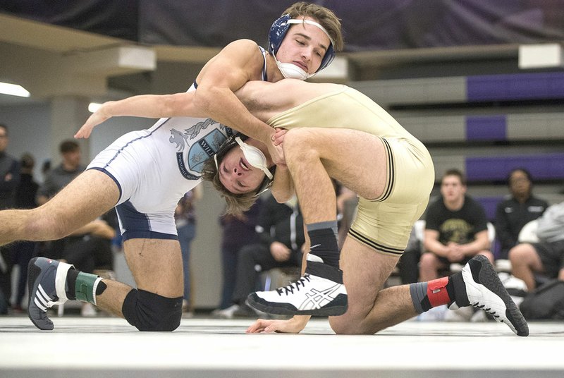 NWA Democrat-Gazette/BEN GOFF @NWABENGOFF Springdale Har-Ber's Jackson Nichols (left) secures his hold of Bentonville High's Gabe Holley on Saturday in a 138-pound match during the Arkansas Wrestling Coaches/Officials Association Dual State Tournament at Fayetteville High School.