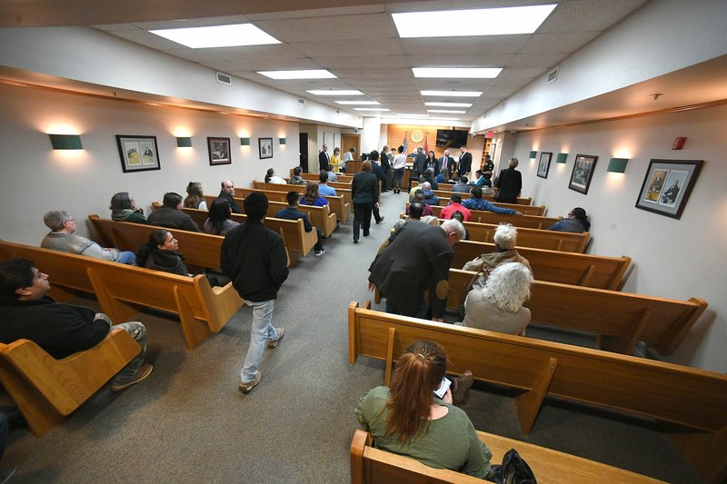 NWA Democrat-Gazette/J.T. WAMPLER Lawyers and defendants arrive Thursday into district court in Springdale. The courtroom capacity is 132 but often people spill into the halls due to overcrowding.