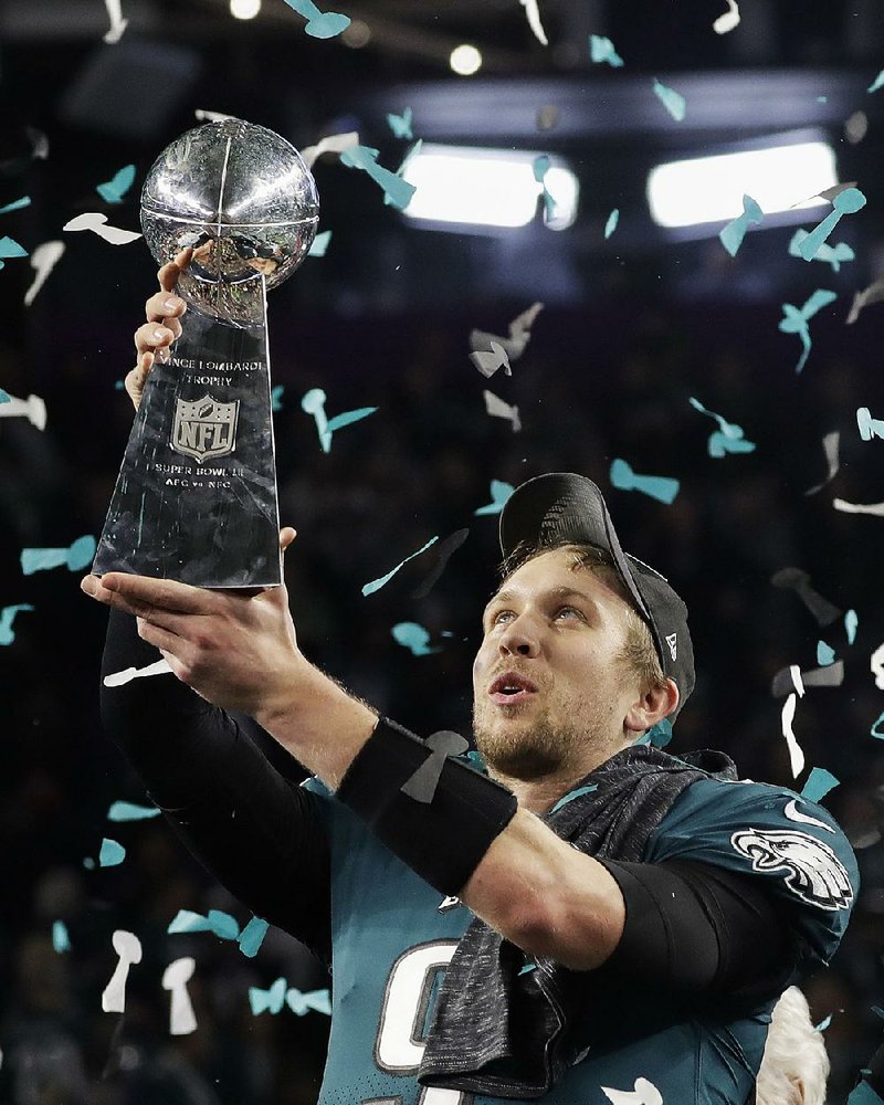 Philadelphia Eagles quarterback Nick Foles holds up the Vince Lombardi Trophy after the Eagles stunned the New England Patriots 41-33 in Super Bowl LII on Sunday in Minneapolis. It was the fi rst Super Bowl title for the Eagles.