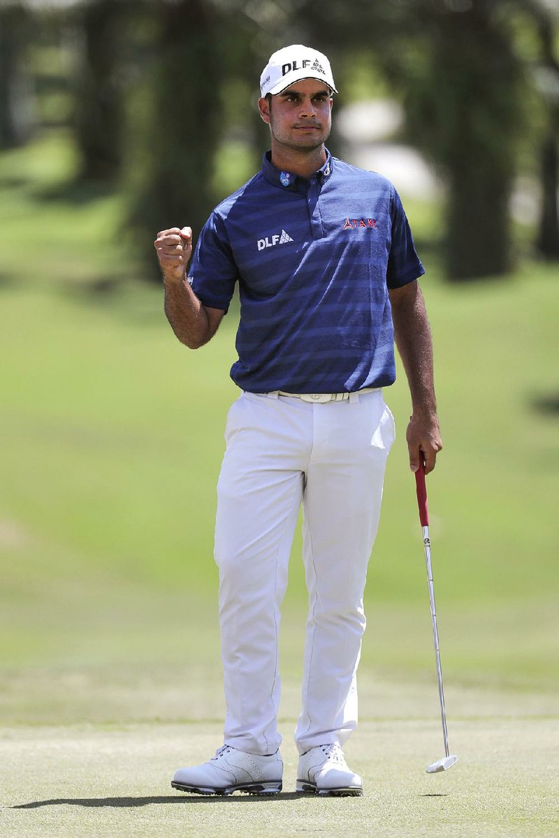 India's Shubhankar Sharma celebrates after scored on the 18th hole during the final round of the Maybank Championship golf tournament in Kuala Lumpur, Malaysia, Sunday, Feb. 4, 2018. 