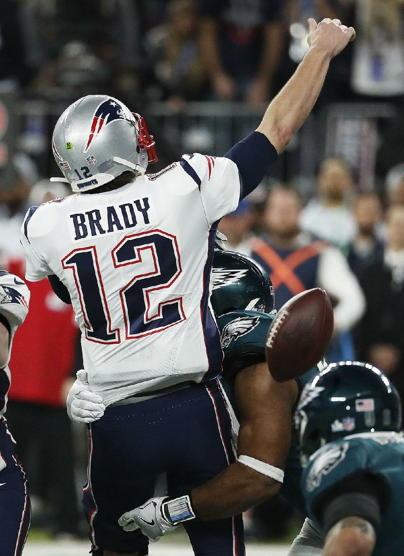 New England Patriots quarterback Tom Brady loses the ball when getting sacked by Philadelphia’s Brandon Graham in the fourth quarter of Super Bowl LII. The fumble set up a field goal by Jake Elliott to help seal the Eagles’ 41-33 victory.