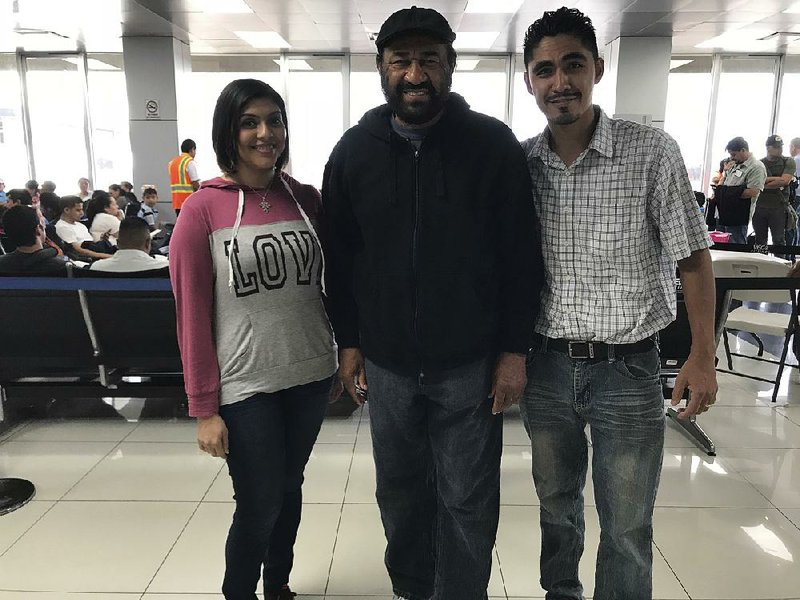 U.S. Rep. Al Green (center) meets with Jose Escobar and his wife, Rose, at the airport in San Salvador, El Salvador, on Saturday. Jose Escobar, who lived in the Houston Democrat’s district, was deported in March despite not having a criminal record, his family said.