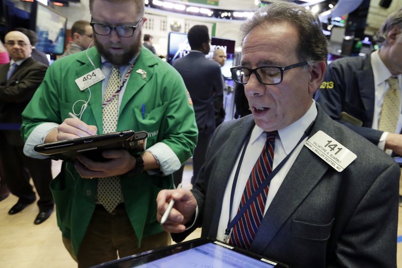 Traders Sal Suarino, right, and Ryan Falvey work on the floor of the New York Stock Exchange, Monday. Stock markets around the world took another pummeling Monday as investors continued to fret over rising U.S. bond yields. (AP Photo/Richard Drew)