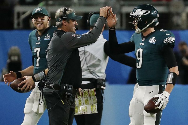Philadelphia Eagles quarterback Nick Foles (right) celebrates with Coach Doug Pederson during Sunday’s game against the New England Patriots. Foles, who replaced starter Carson Wentz in Week 14, earned Super Bowl MVP honors after leading the Eagles to their first Super Bowl title.
