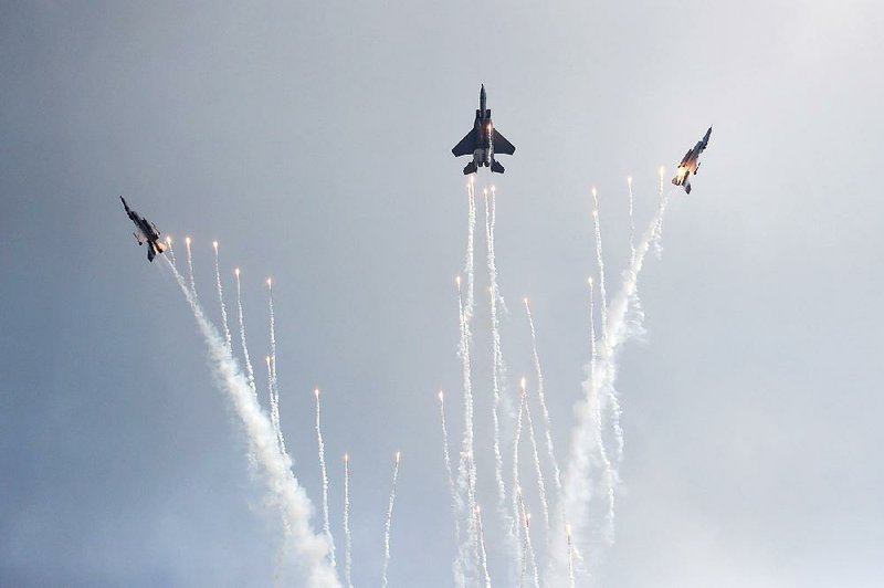 Republic of Singapore Air Force fighter jets perform maneuvers Sunday during a media preview day for the Singapore Airshow, which begins today.