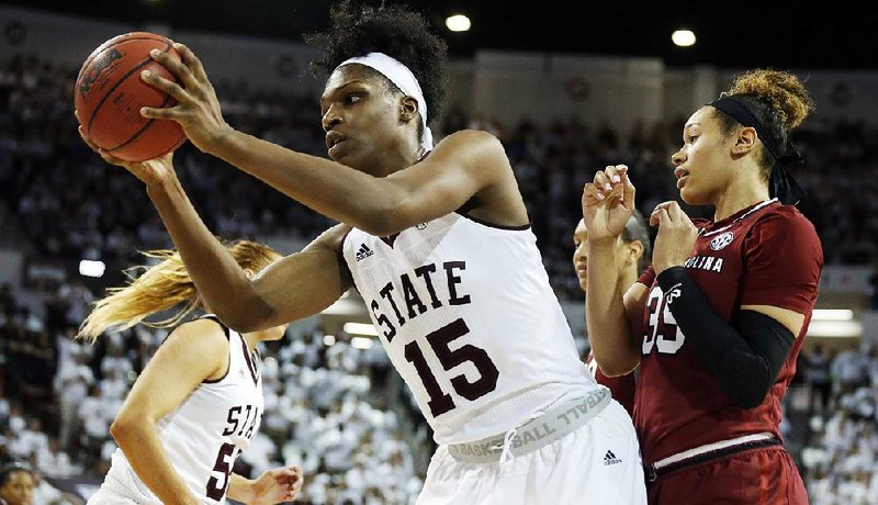 Mississippi State center Teaira McCowan (left) pulls down a rebound from South Carolina forward Alexis Jennings during the second half Monday in Starkville, Miss. McCowan fi nished with nine points and a career-high 20 rebounds as Mississippi State won 67-53.