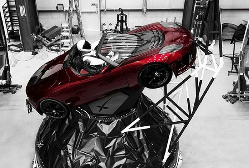 A mannequin dubbed “Starman” sits at the wheel of a Tesla Roadster that will be on board when Elon Musk’s Space Exploration Technologies Corp. launches its new SpaceX rocket, the Falcon Heavy, from Kennedy Space Center at Cape Canaveral, Fla., possibly today.
