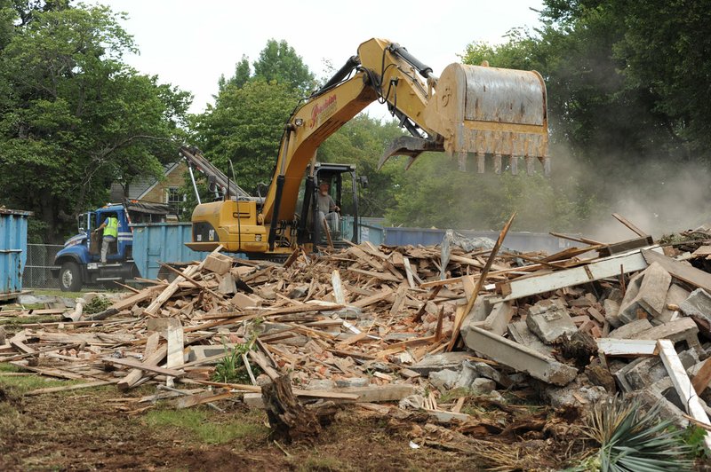 NWA Democrat-Gazette/ANDY SHUPE Workers operate heavy equipment Aug. 9 to demolish Stone-Hilton House at 306 E. Lafayette St. in Fayetteville.