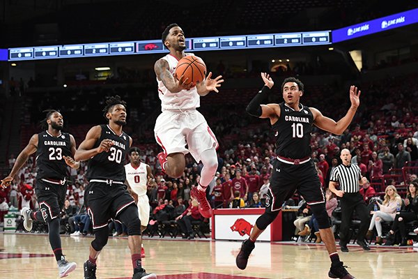 Arkansas' Daryl Macon goes up for a shot in front of South Carolina's Chris Silva (30) and Jutin Minaya (10) during a game Tuesday, Feb. 6, 2018, in Fayetteville. 