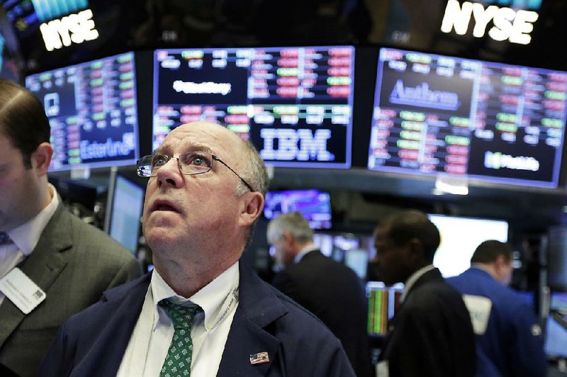 Trader Frederick Reimer keeps watch Tuesday on the floor of the New York Stock Exchange as prices seesaw. 