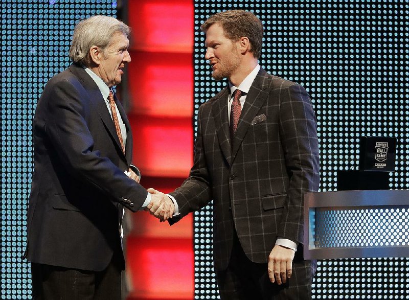 Dale Earnhardt Jr. (right) greets broadcaster Ken Squier at the NASCAR Hall of Fame ceremony in January in Charlotte, N.C. Earnhardt has retired from racing and will be part of NBC’s Winter Olympics coverage this month. 