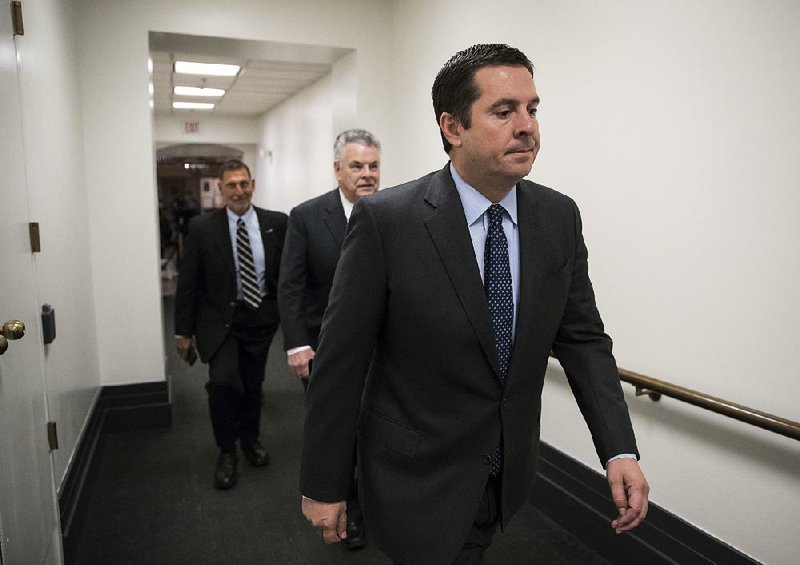 House Intelligence Committee Chairman Devin Nunes (front) heads to a GOP conference Tuesday along with Rep. Peter King (middle), R-N.Y. Democrats have asked whether Nunes coordinated with the White House in drafting the GOP memo on the investigation into Russia’s interference in the 2016 presidential election.  
