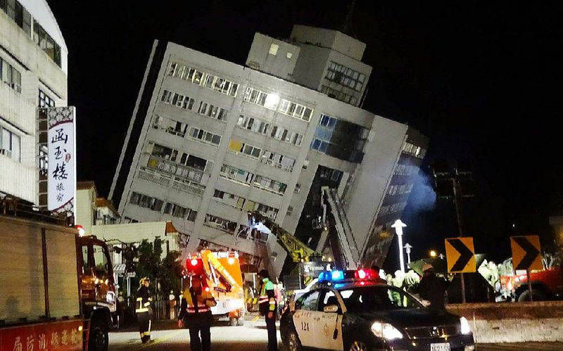 Rescuers enter a hotel that collapsed during an earthquake Tuesday near the coast of Taiwan. Two hotel workers were killed and at least 200 people were injured. Other buildings also were damaged by the magnitude-6.4 quake, officials said. 