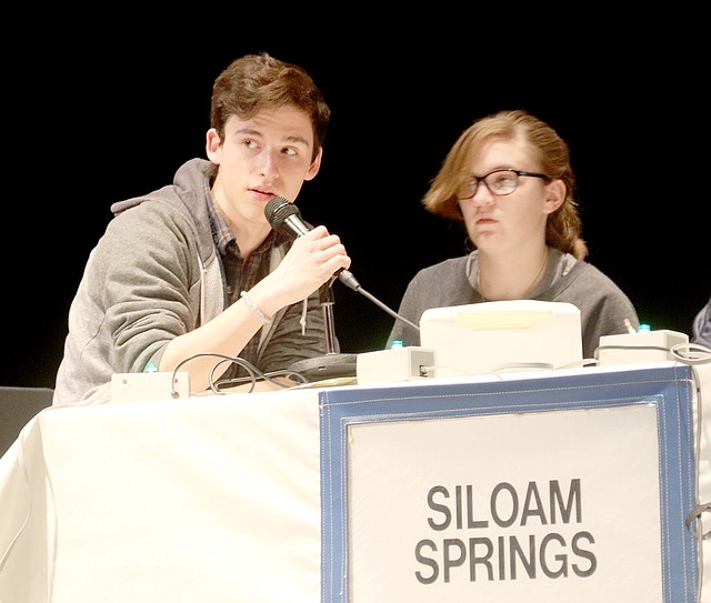 Lynn Kutter/Washington County Enterprise-Leader Avery Lang, a member of the Siloam Springs High School's Academic Competition in Education team, answers a question during a match on Jan. 25 at the Farmington Performing Arts Center. Brookie Hutto is seated next to Lang. Siloam Springs scored 12 points and came in third place in its match against Farmington (56 points) and Bentonville West (23 points). ACE is a regional competition that involves nine schools in Northwest Arkansas. The top seven teams advance to the championship matches on Feb. 21.
