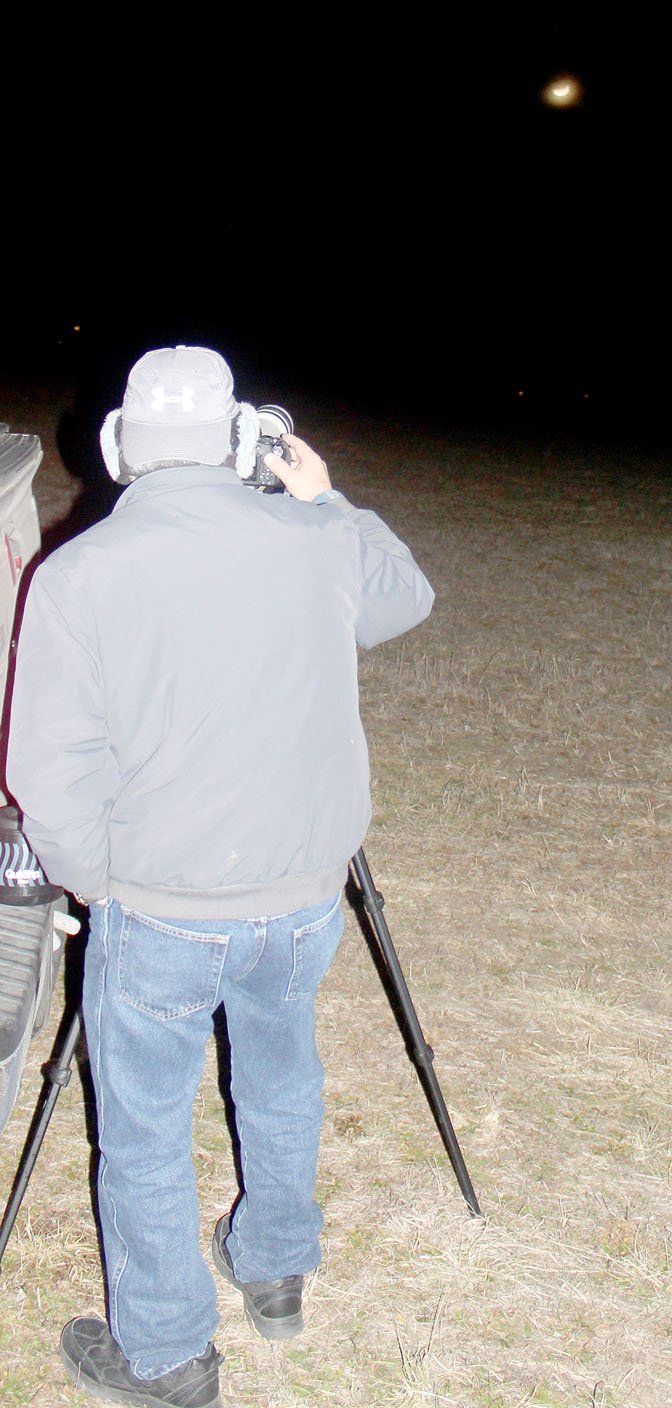 Keith Bryant/The Weekly Vista Bella Vista/Bentonville Photography Club member Dana Johnson snaps photos of the moon mid-eclipse.