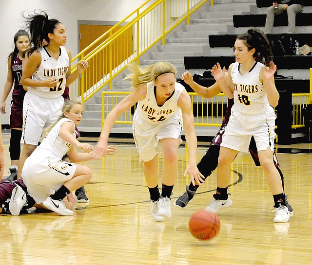 MARK HUMPHREY ENTERPRISE-LEADER Prairie Grove senior Sarah James-Stone comes out of a scramble for a loose ball with the dribble gaining possession for the Lady Tigers. Prairie Grove needed overtime to beat Lincoln, 58-50, Friday.