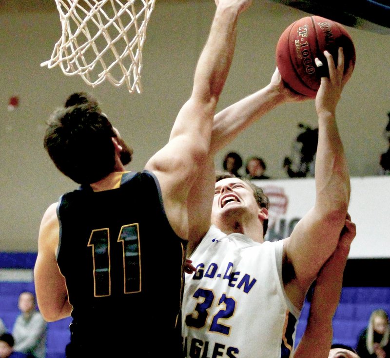 Photo courtesy of JBU Sports Information John Brown sophomore forward Mateo Habazin goes up against Ecclesia's Noah Banks during Saturday's game at Bill George Arena. John Brown defeated Ecclesia 94-49.
