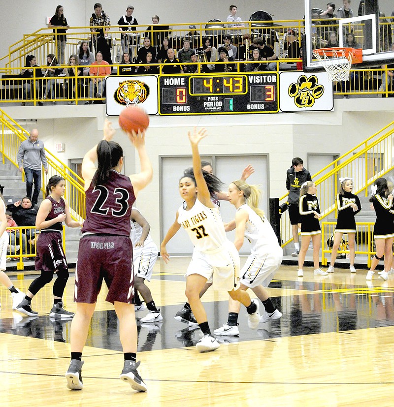 MARK HUMPHREY ENTERPRISE-LEADER Lincoln senior Tristan Cunningham had the hot hand in the first half, nailing a trio of 3-pointers, including this shot. Cunningham scored 16 points in the Lady Wolves' 58-50 overtime loss to Prairie Grove Friday.
