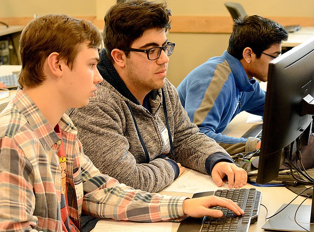 Janelle Jessen/Herald-Leader Haas Hall Academy students Meso Ata, Andrew Younger and Sal Sirigineedi worked on a problem during the 2018 Programming Competition at John Brown University.