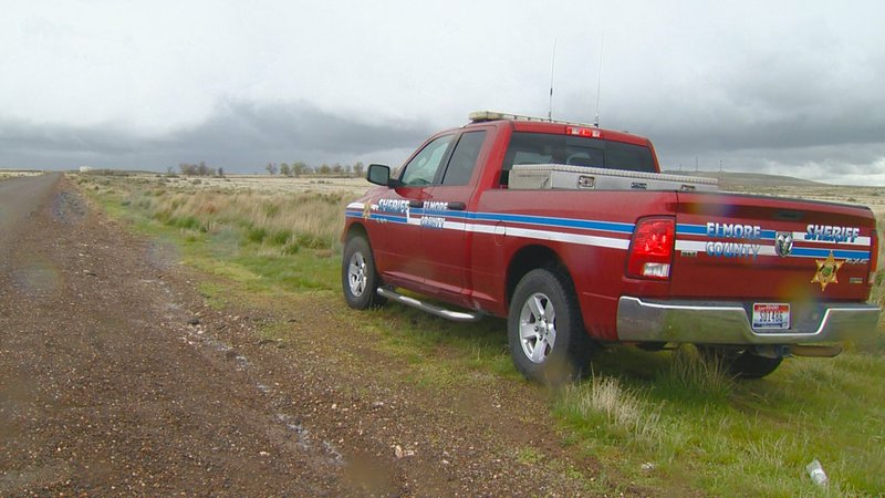 FILE - This April 15, 2017, file video image courtesy of KTVB-TV, shows an Elmore County Sheriff vehicle in the remote area where skeletal remains were found in a badger hole north of Mountain Home, Idaho. The U.S. government says it's working with two Native American tribes to return the 500-year-old, well-preserved bones of a young adult and child found in a southwestern Idaho badger hole to one of the tribes. 