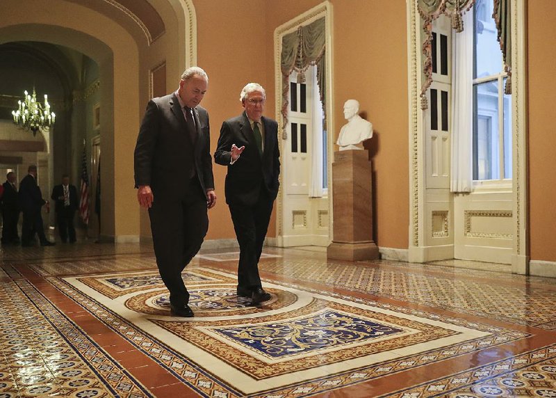 Senate Minority Leader Charles Schumer (left) and Majority Leader Mitch McConnell walk to the Senate chamber Wednesday after reaching a budget agreement. 