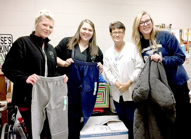 Photo Submitted Nursing students Sarina Hunt (left) and Maegan Mooberry, McDonald County High School nurse Tracy Allman, and nursing student Brittney Jackson show donated items.