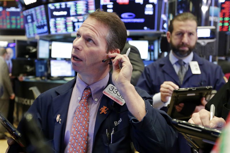 Trader Robert Charmak, left, works on the floor of the New York Stock Exchange on Thursday, Feb. 8, 2018. 