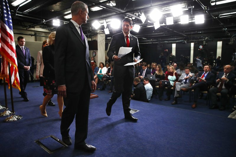 House Speaker Paul Ryan of Wis., center, leaves the podium as he turns toward Rep. Mac Thornberry, chairman of the Armed Services Committee, left, after a news conference, Thursday, Feb. 8, 2018, on Capitol Hill in Washington. The Republican-led Congress on Thursday was rounding up support for a bipartisan budget bill that would put the government on track for annual deficits topping $1 trillion, a gap last seen toward the end of Obama's first term. 