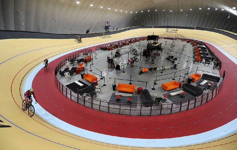 Riders cycle the track in the new Lexus Velodrome in Detroit. The indoor cycling track is expected to draw bike riders from other cold-weather states and give inner-city youth an opportunity to get involved in the sport.
