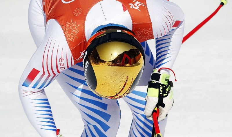 The finish area is reflected in the ski helmet of United States skiier Wiley Maple (shown) during men’s downhill training ahead of the Pyeongchang Winter Olympics on Thursday.
